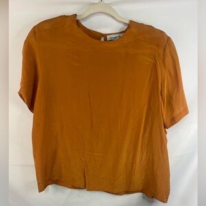 Vintage 100% silk burnt orange blouse by Anna and Frank. Built in shoulder pads.